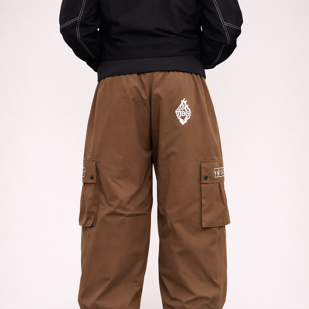 Brown cargo pants with a logo on a light pink background