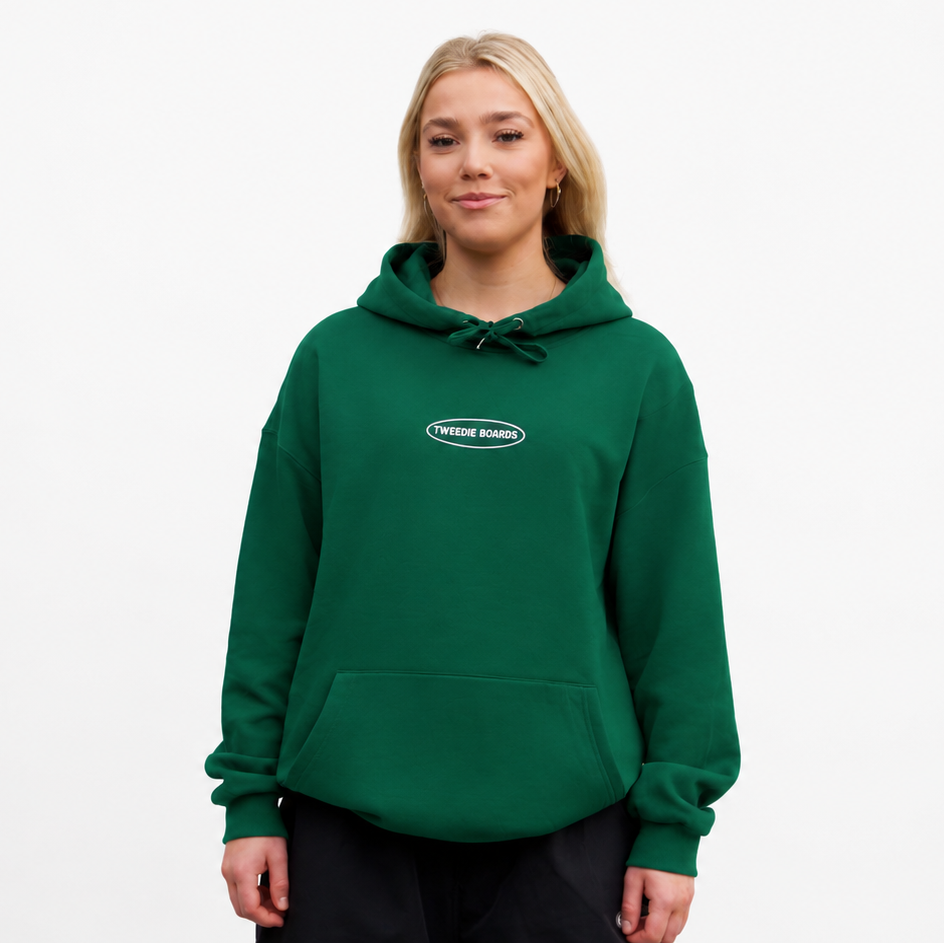 Person wearing a green hoodie with a logo on a white background