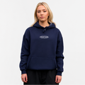 Person wearing a navy blue hoodie with a logo on a white background