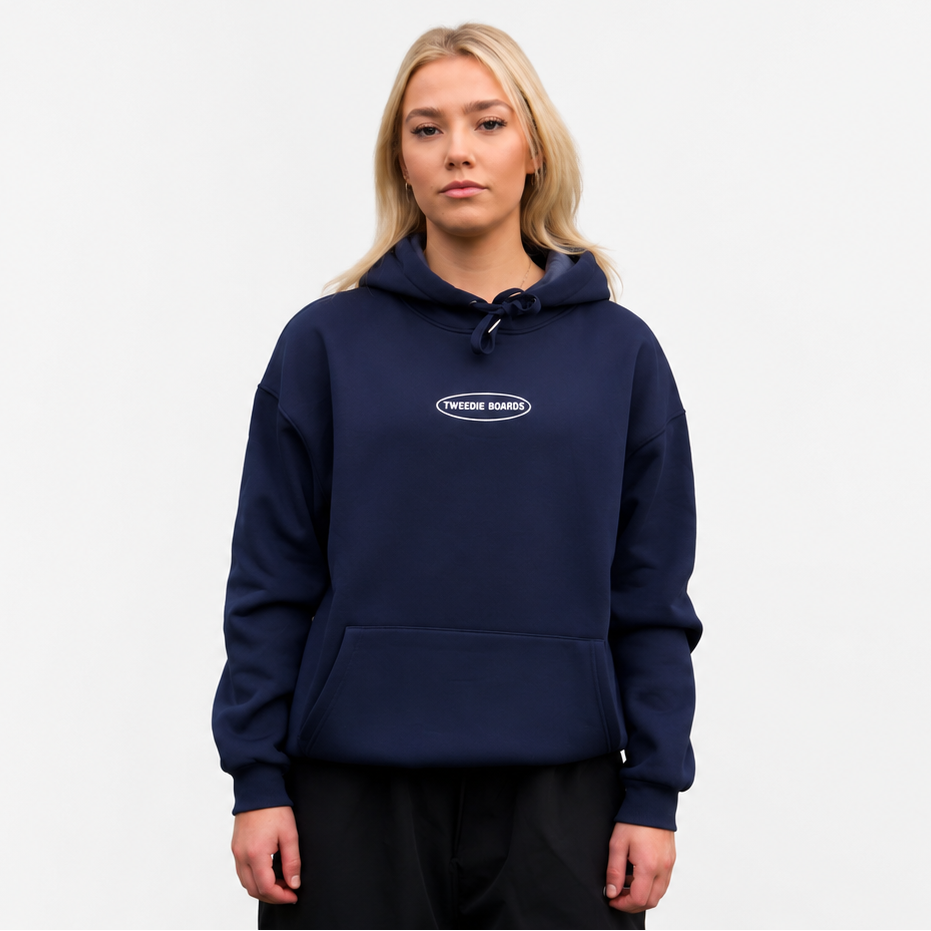 Person wearing a navy blue hoodie with a logo on a white background