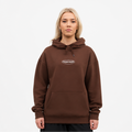Person wearing a brown hoodie with a logo on a white background