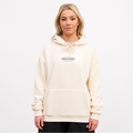 Person wearing a cream hoodie with a logo on a white background