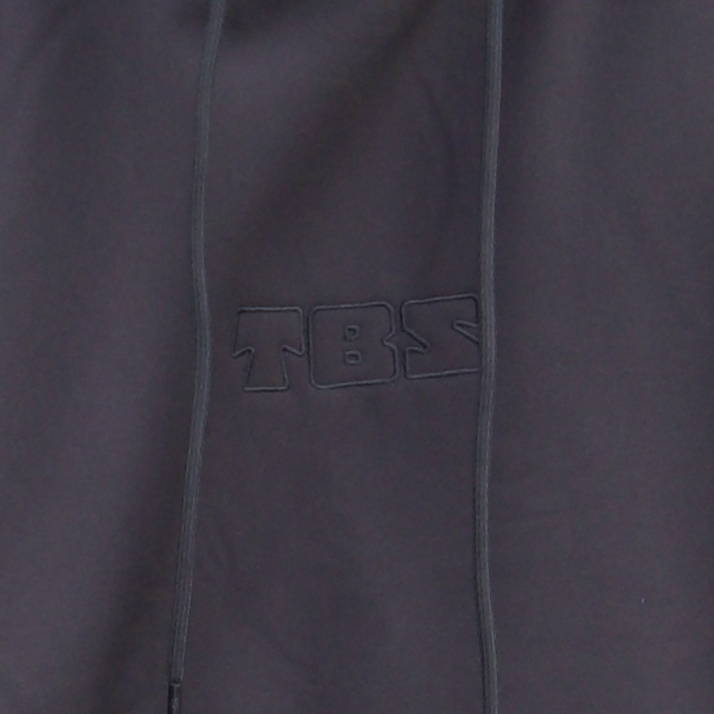 Close-up of a dark gray jacket with a brand logo on the chest pocket.